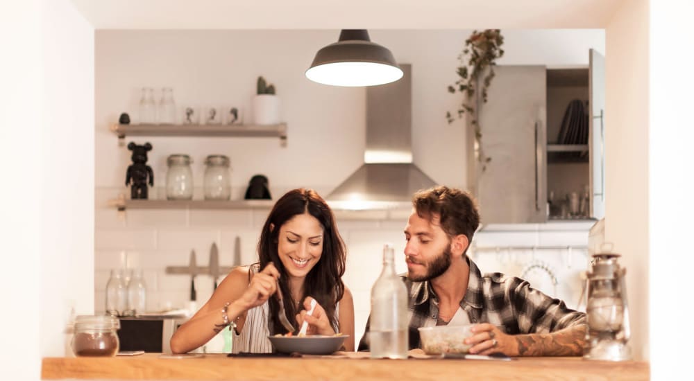 A couple eating in kitchen at Pinnex in Indianapolis, Indiana