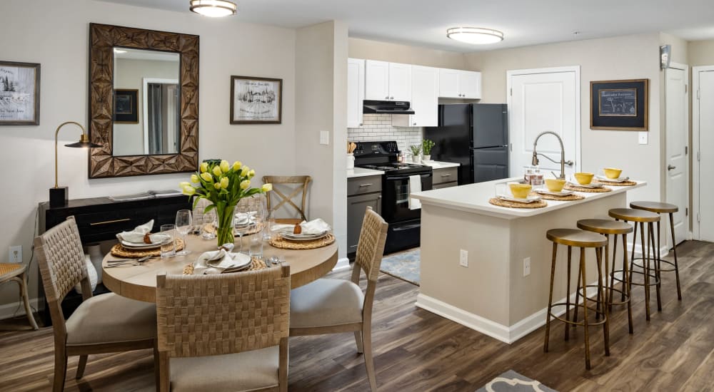 A dining area and open kitchen at Heritage at Riverstone in Canton, Georgia