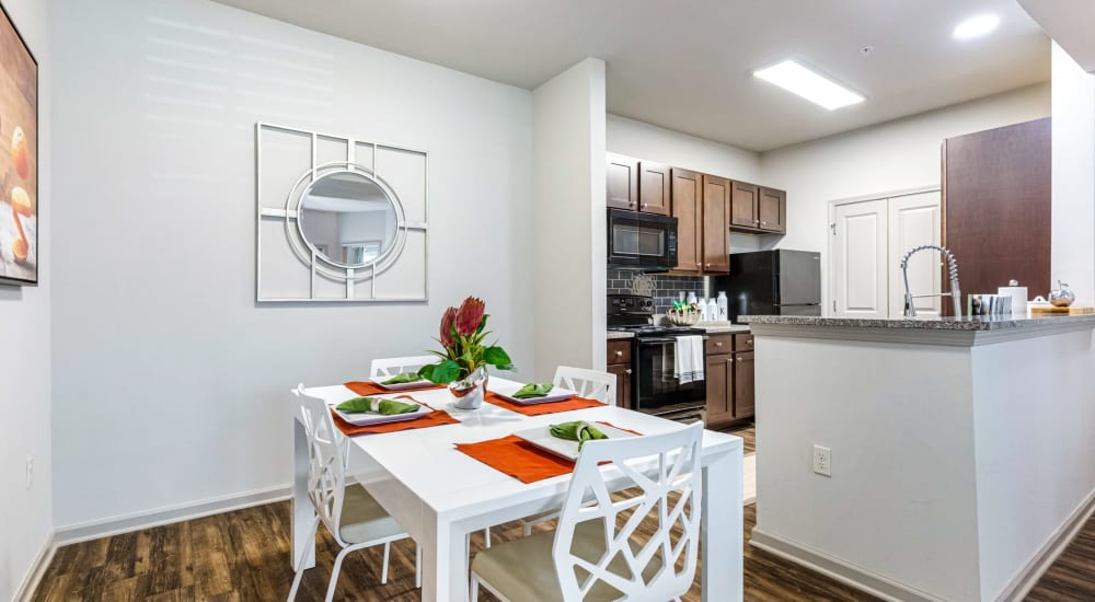 A dining area and open kitchen at Reagan Crossing in Covington, Louisiana