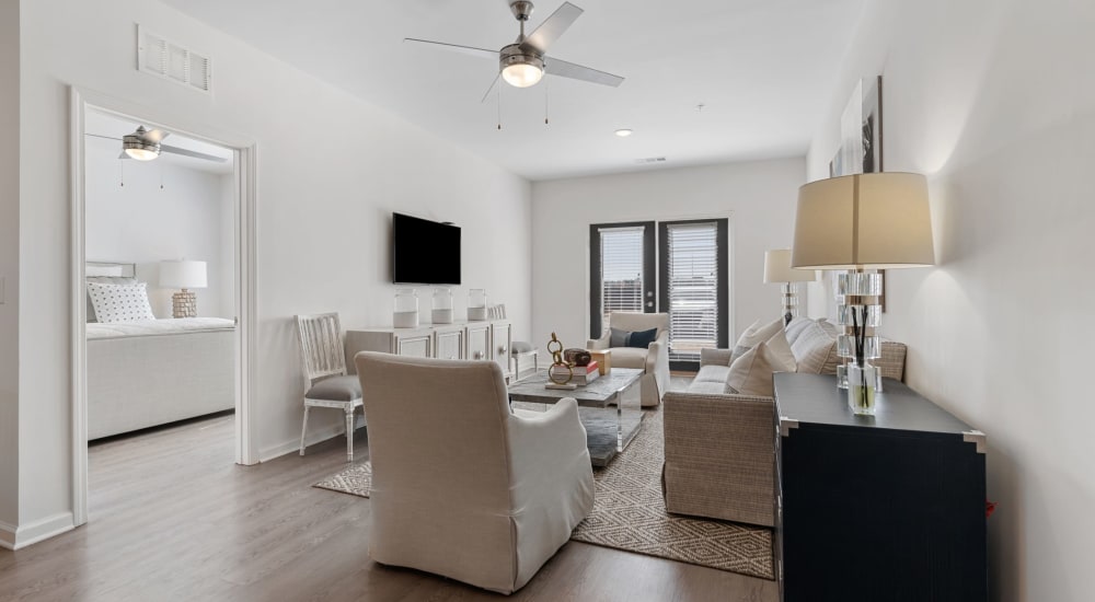 A furnished apartment living room and bedroom at The Station at Clift Farm in Madison, Alabama