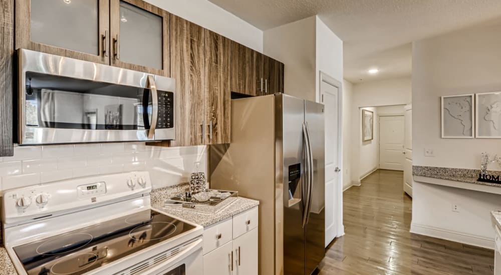 Upgraded stainless steel kitchen appliances in an apartment kitchen at EOS in Orlando, Florida