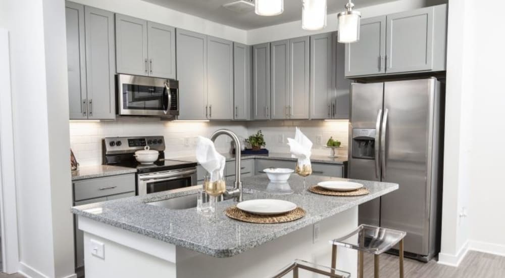 A dining area and open kitchen at Retreat at Fairhope Village in Fairhope, Alabama