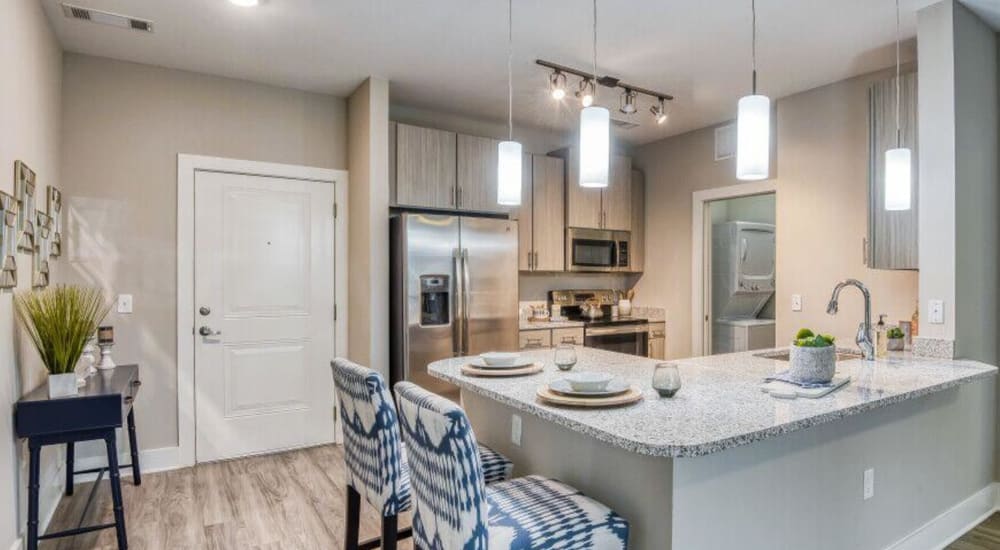 A dining area and open kitchen at The Lively Indigo Run in Ladson, South Carolina