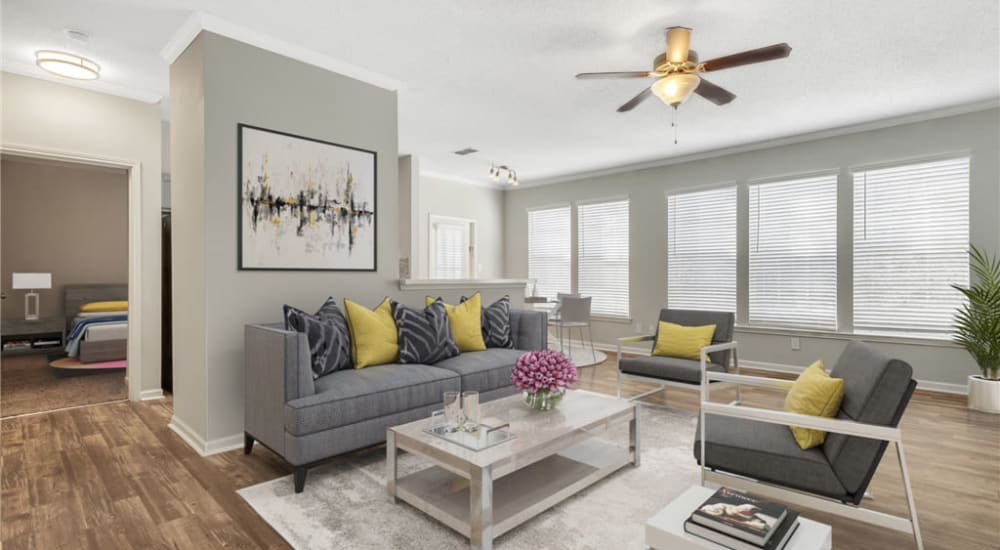 A furnished apartment living room with wood flooring at Astoria in Mobile, Alabama