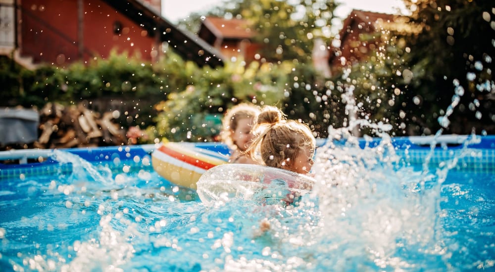 Kids swimming in pool near The Enclave at Delray Beach in Delray Beach, Florida