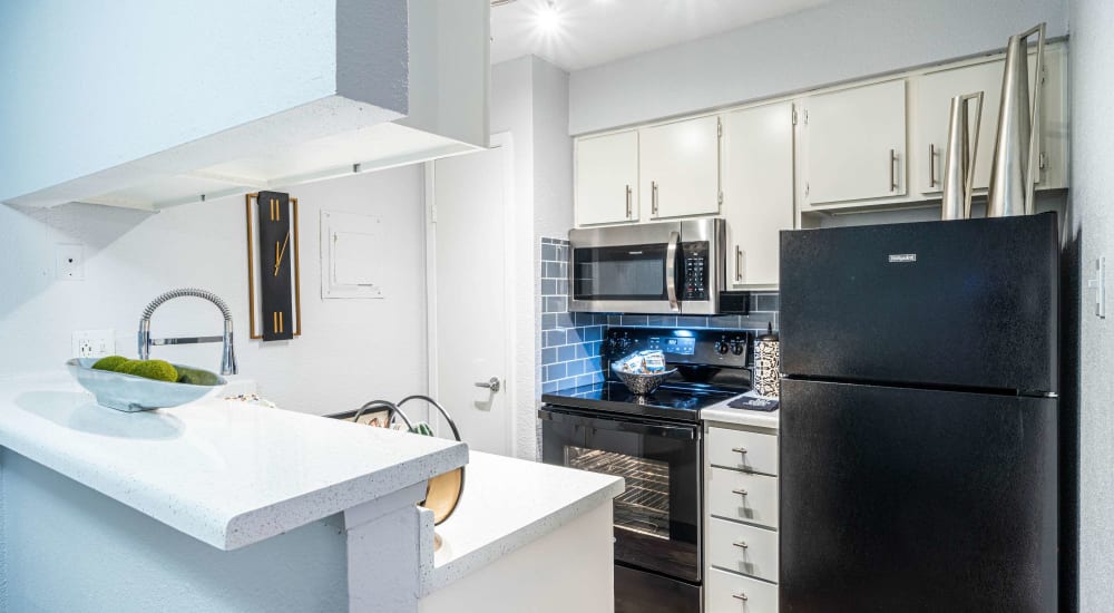 Modern kitchen with energy-efficient appliances at The Edge at Clear Lake in Webster, Texas