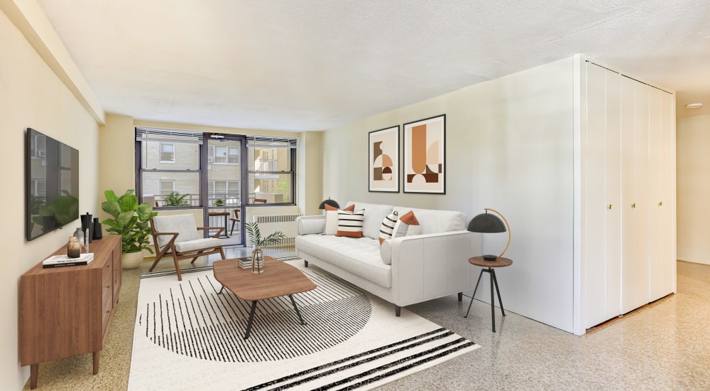 Model living space with white accents and wall art at Tower West Apartments in New York, New York