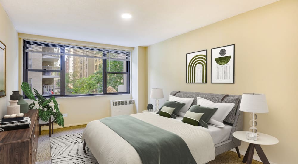 Model bedroom with large window at Tower West Apartments in New York, New York