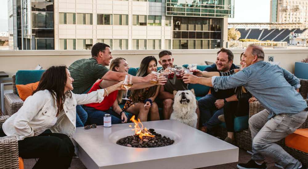 Residents with sparklers at the rooftop lounge at twilight at Urbana Rental Flats in San Diego, California