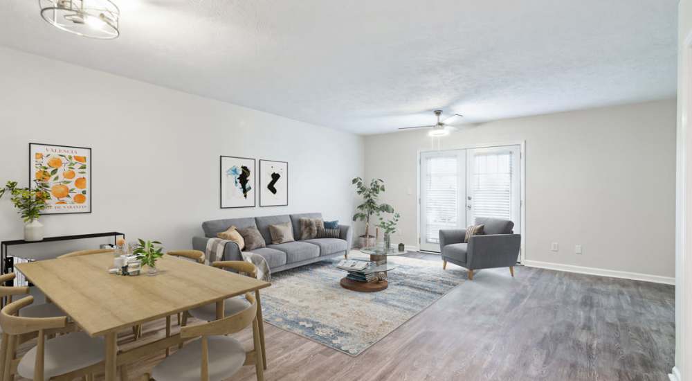 Spacious living room with vinyl flooring and natural lighting from large patio door at The Reserve At Lebanon in Lebanon, Tennessee