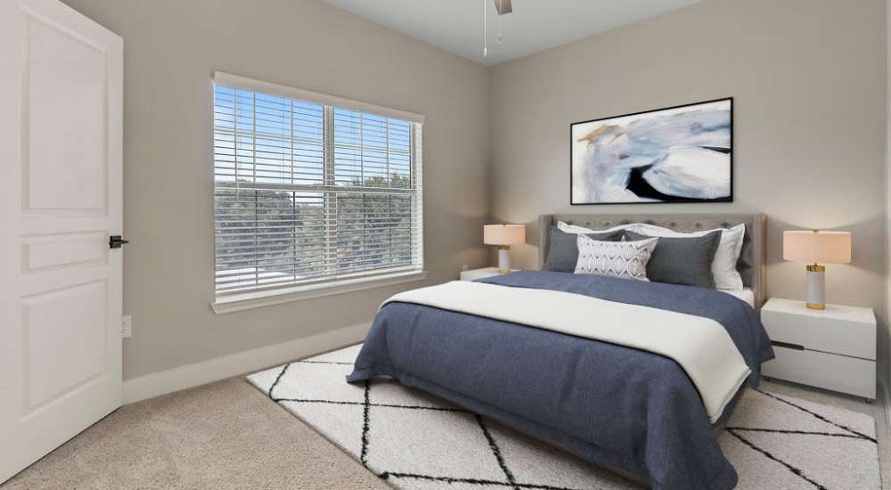 Leather couch and a comfortable chair in a model home's living space at Oakville Apartments in Austin, Texas