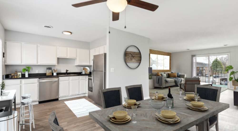 Stainless-steel appliances in an apartment kitchen with wooden style flooring and side door at Midvale Heights in Chattanooga, Tennessee