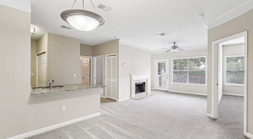 Unfurnished living room with fireplace at Grande Oaks in Roswell, Georgia