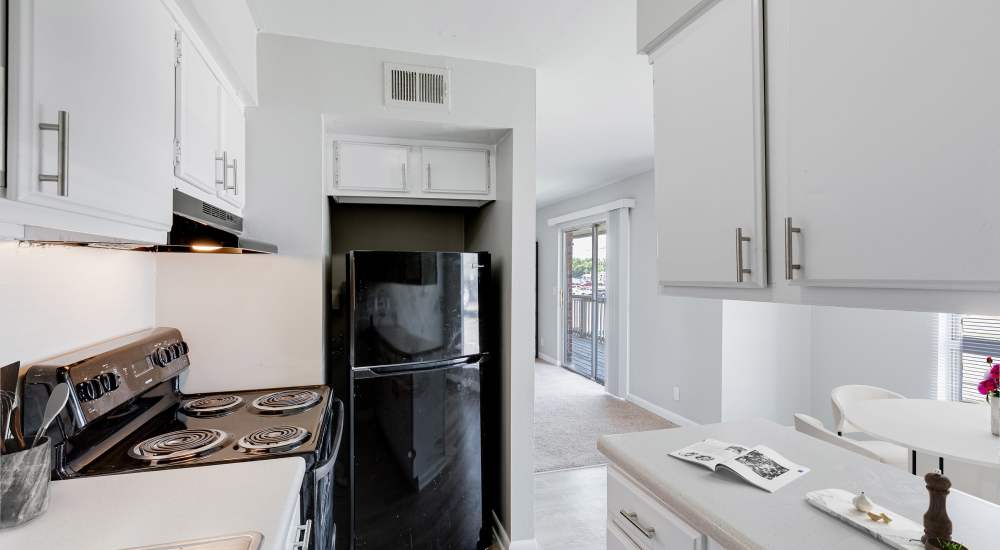 Spacious living room with glass door leading to balcony at The Edge On Main in Lebanon, Tennessee