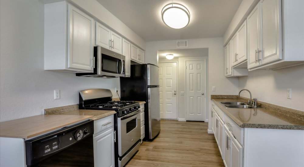 Modern kitchen with white color cabinet at San Jose Greens in San Jose, California