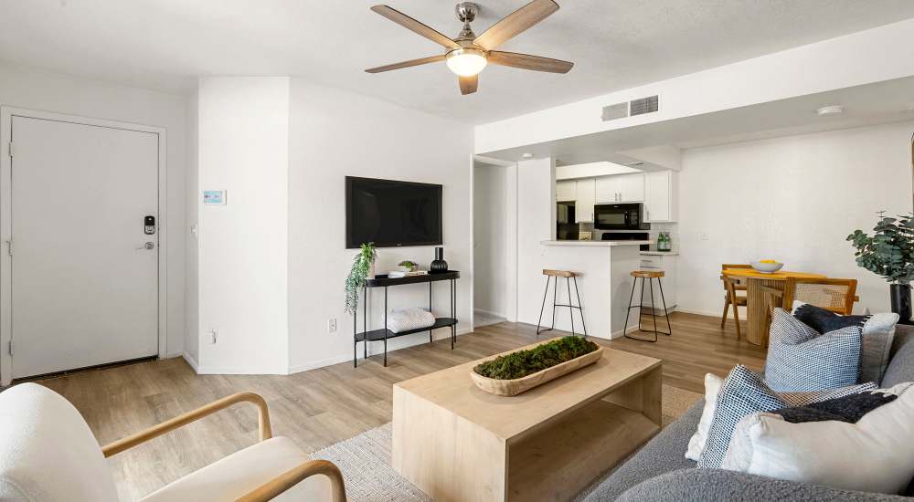 living room with ceiling fan and view of kitchen