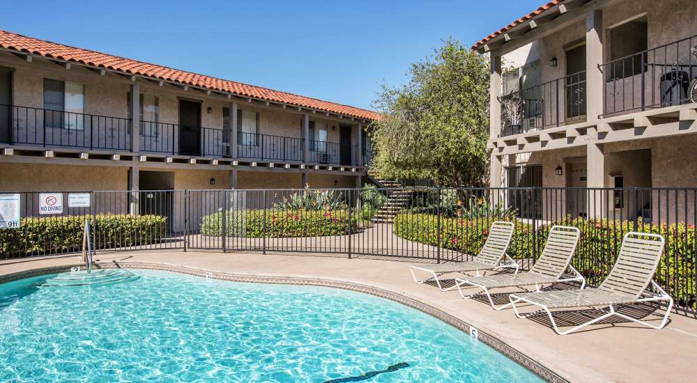 Serene swimming pool with lounge chairs at Casa Madrid in Cypress, California