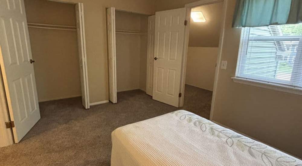 Bedroom with closet area at Woodland Estates in East Rochester, New York