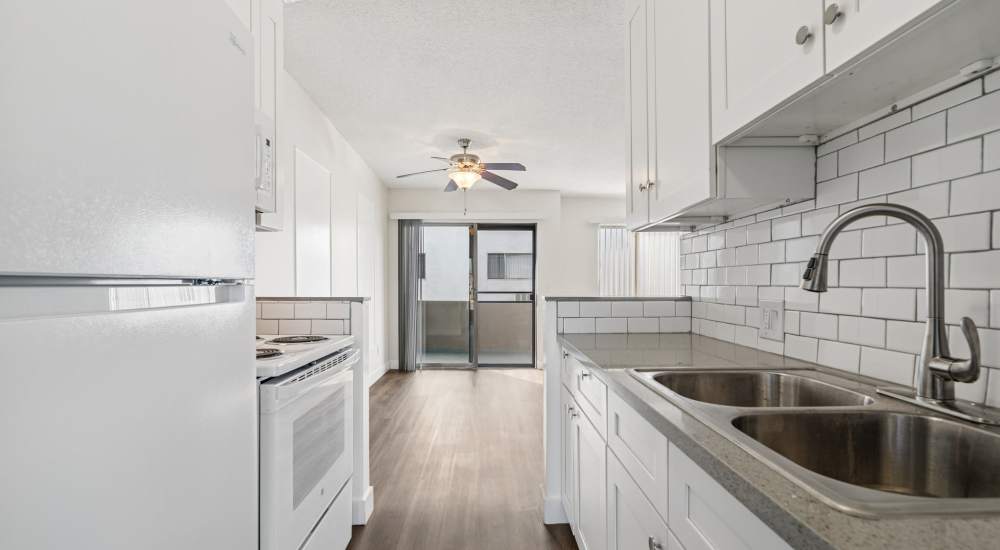 Apartment kitchen with white granite countertop at Regency in Sherman Oaks, California