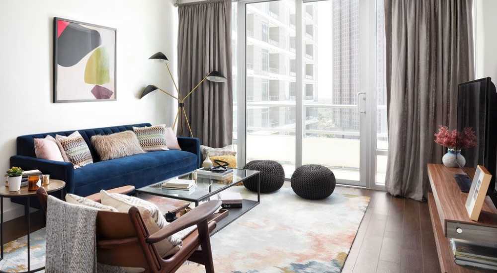 Living room with floor to ceiling windows at Ardan in Dallas, Texas