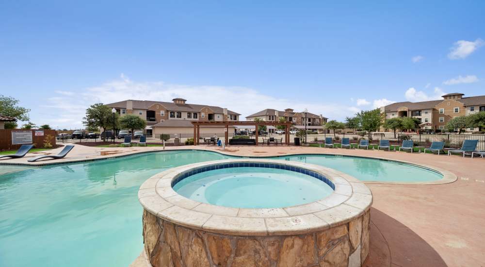 Resort-style hot tub with pool at Sunset Lodge in Odessa, Texas                                