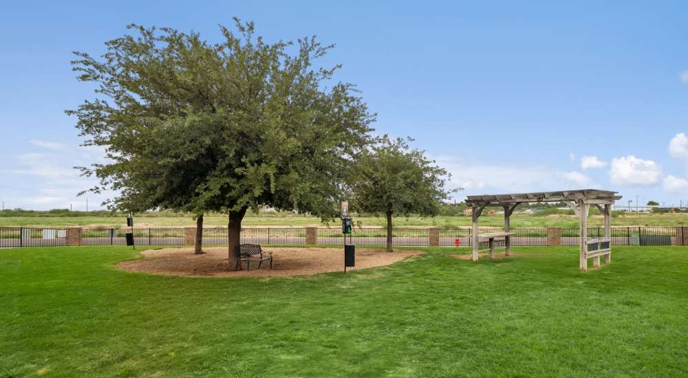 Fenced pet park with bench and pet waste stations at Vistas at Red Creek in San Angelo, Texas 