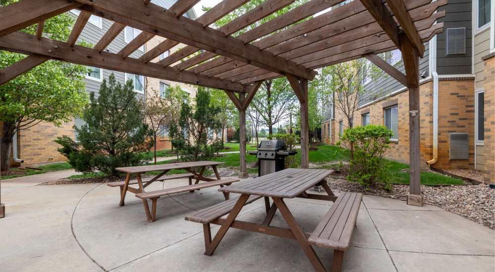 Wooden bench sitting with beautiful pergola and plants at WaterWalk Wichita - Downtown in Wichita, Kansas