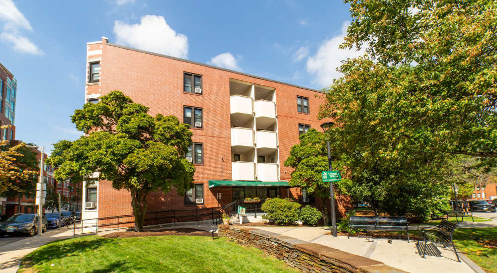 Red brick building with green awning at 15-25 Hemenway Apartments in Boston, Massachusetts