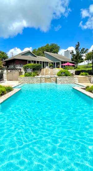 Swimming pool with cascading waterfalls at The Abbey at Medical Center in San Antonio, Texas  