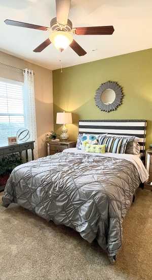 Bedroom with king size bed at The Abbey at Stone Oak in San Antonio, Texas