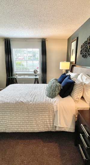 Bedroom with large window and blinds at The Abbey at Regent's Walk in Homewood, Alabama