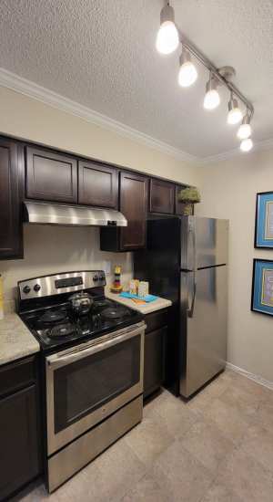 Modern kitchen and stainless steel appliances at The Abbey At Northlake in Riviera Beach, Florida
