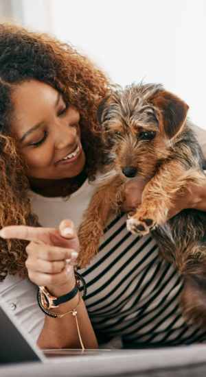 Resident holding her dog at The Abbey at Grande Oaks in San Antonio, Texas