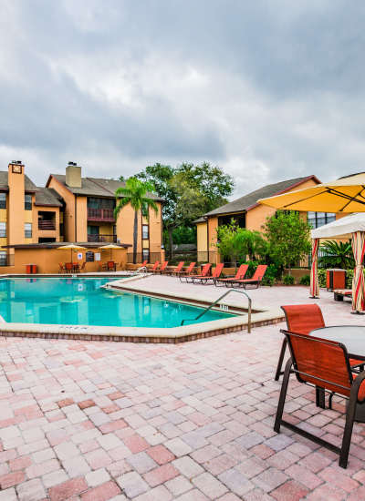 Pool with lounge furniture at Waterstone At Carrollwood in Tampa, Florida