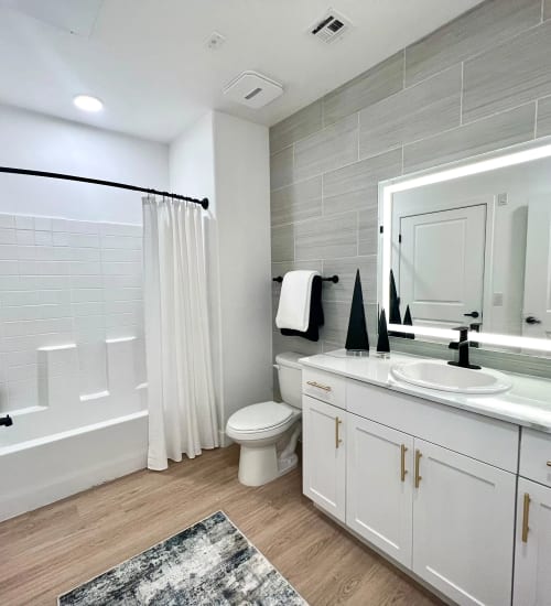 Bathroom with lighted mirror at Zinc 1501 in Sacramento, California