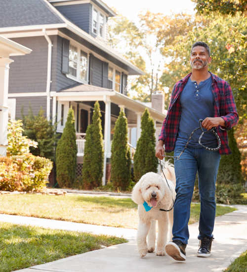 A resident walkin his dog near Unionville Station Townhomes in Hilton, New York