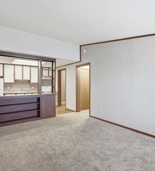 Living room with carpet and kitchen access at Live Hilliard OH in Hilliard, Ohio