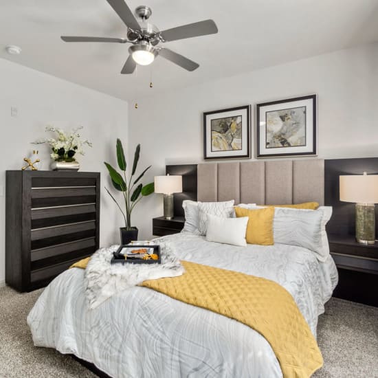 Bed and nightstand in a model home's bedroom at Discovery at Kingwood in Kingwood, Texas