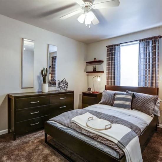 Bed and nightstand in a model home's bedroom at The Boulevard in Roeland Park, Kansas