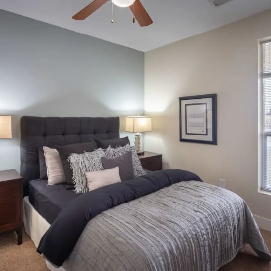 Cozy bed and nightstand in a model home's bedroom at CityView in North Kansas City, Missouri