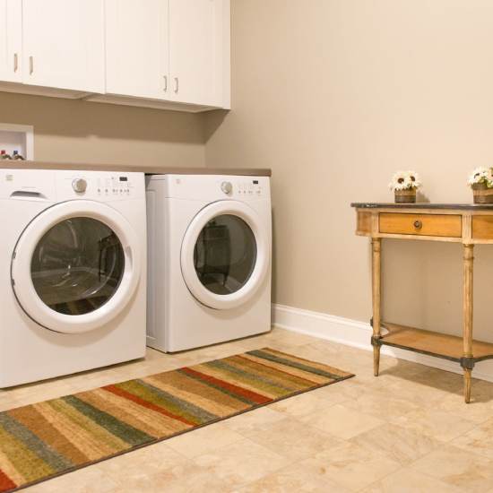 Neatly organized laundry room with washer and dryer at Fairways Villas II Apartments in Victor, New York