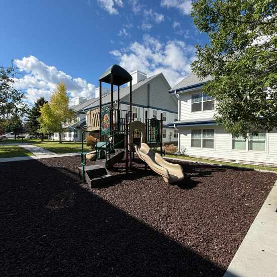 Woman and child playing at a playground near Baxter Apartments in Bozeman, Montana