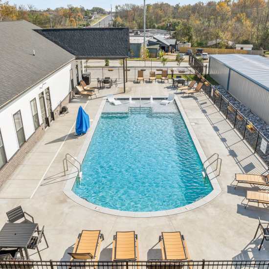 Resort-style swimming pool with sun loungers by the poolside at West Fork Crossings in Clarksville, Tennessee   