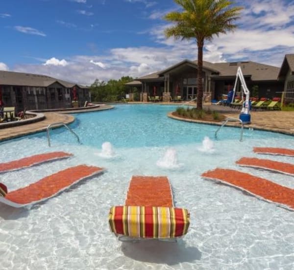 The resort-style swimming pool with seating at Retreat at Fairhope Village in Fairhope, Alabama