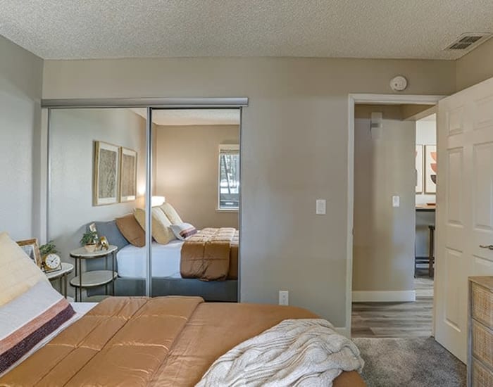 An apartment bedroom with closet at Austin Commons Apartments in Hayward, California