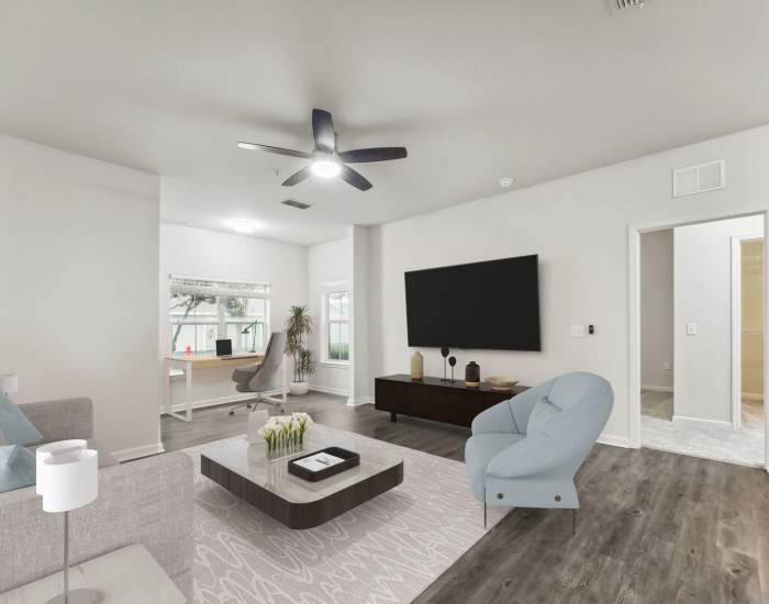 Living room with vinyl flooring, ceiling fan, comfortable couch and a coffee table at The Haven At West Melbourne in West Melbourne, Florida