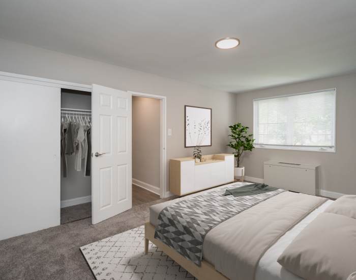 Pleasing bedroom with large bed and windows at Braddock Lee Apartments in Alexandria,Virginia