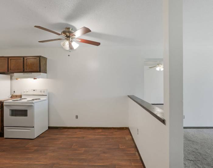 An apartment bedroom with wood-style flooring at Larpenteur Villa in Saint Paul, Minnesota