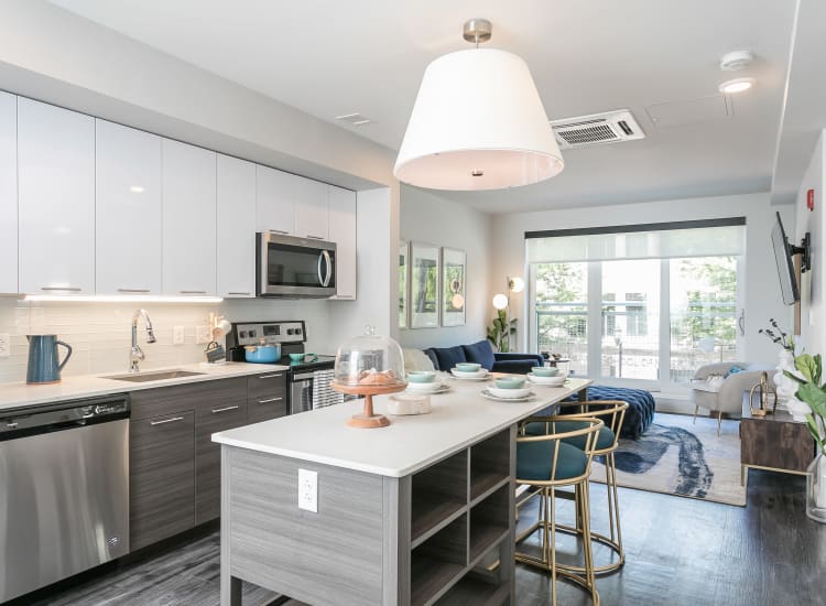Stainless-steel appliances and custom cabinetry in a model home's kitchen at City Centre Ithaca in Ithaca, New York