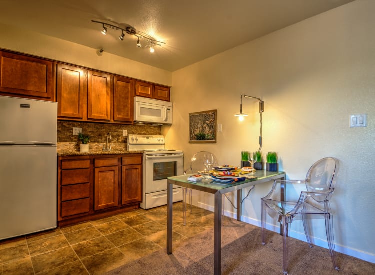 Cherry wood cabinetry and custom lighting in a model senior apartment at Bella Vista Senior Living in Mesa, Arizona